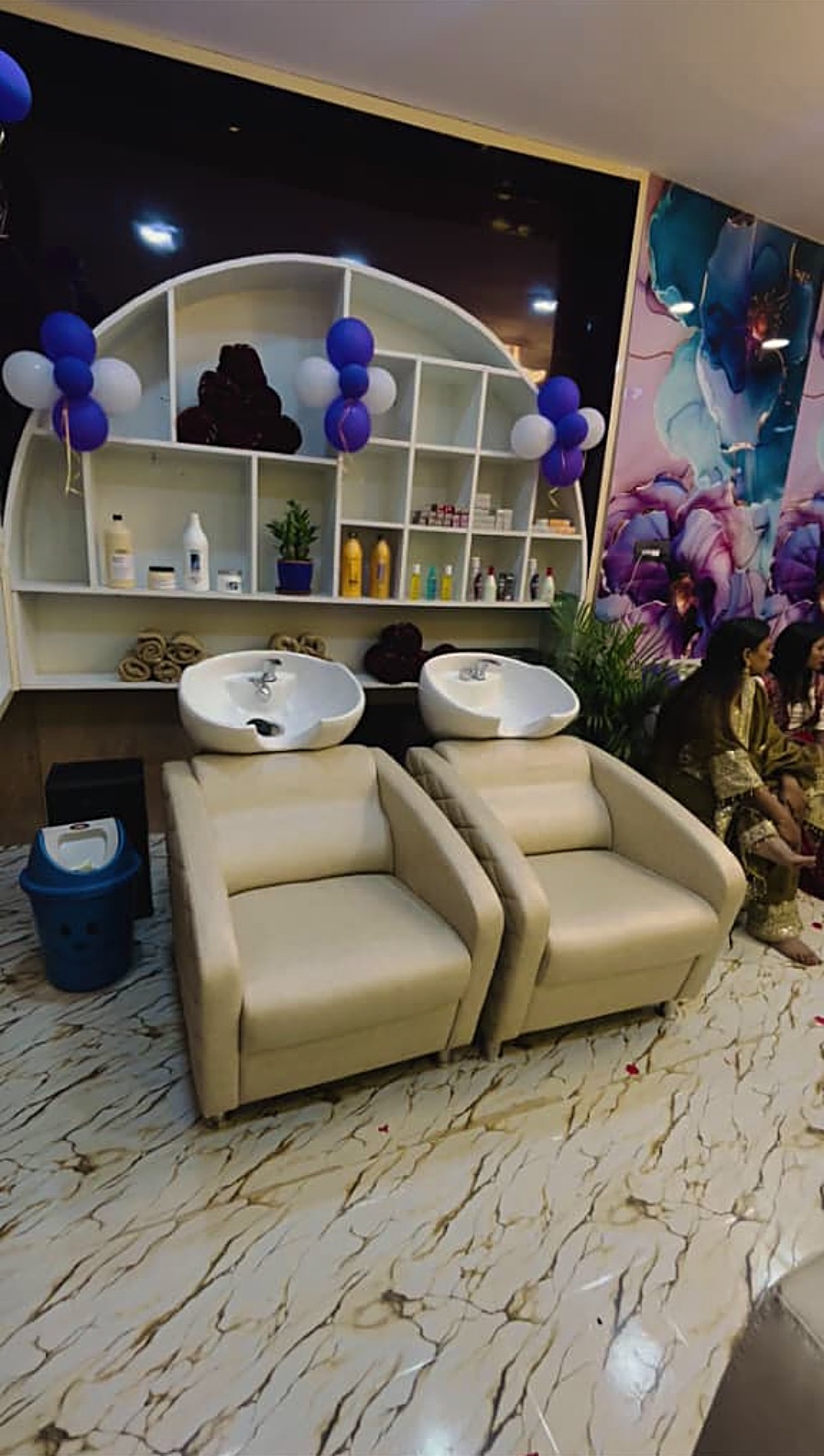 Hair wash stations and product shelf at The Salon Vibe, Chandrapur
